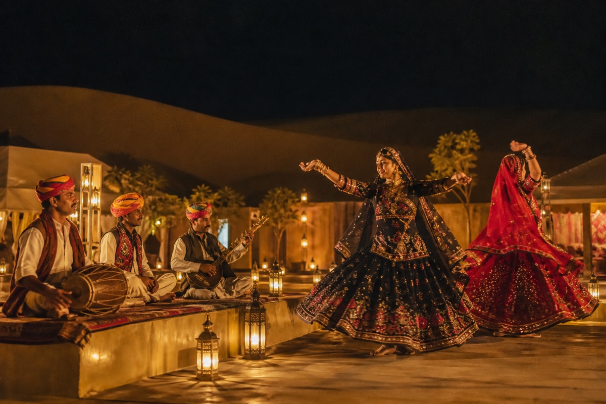 Rajasthani folk performers in a lantern-lit desert camp courtyard