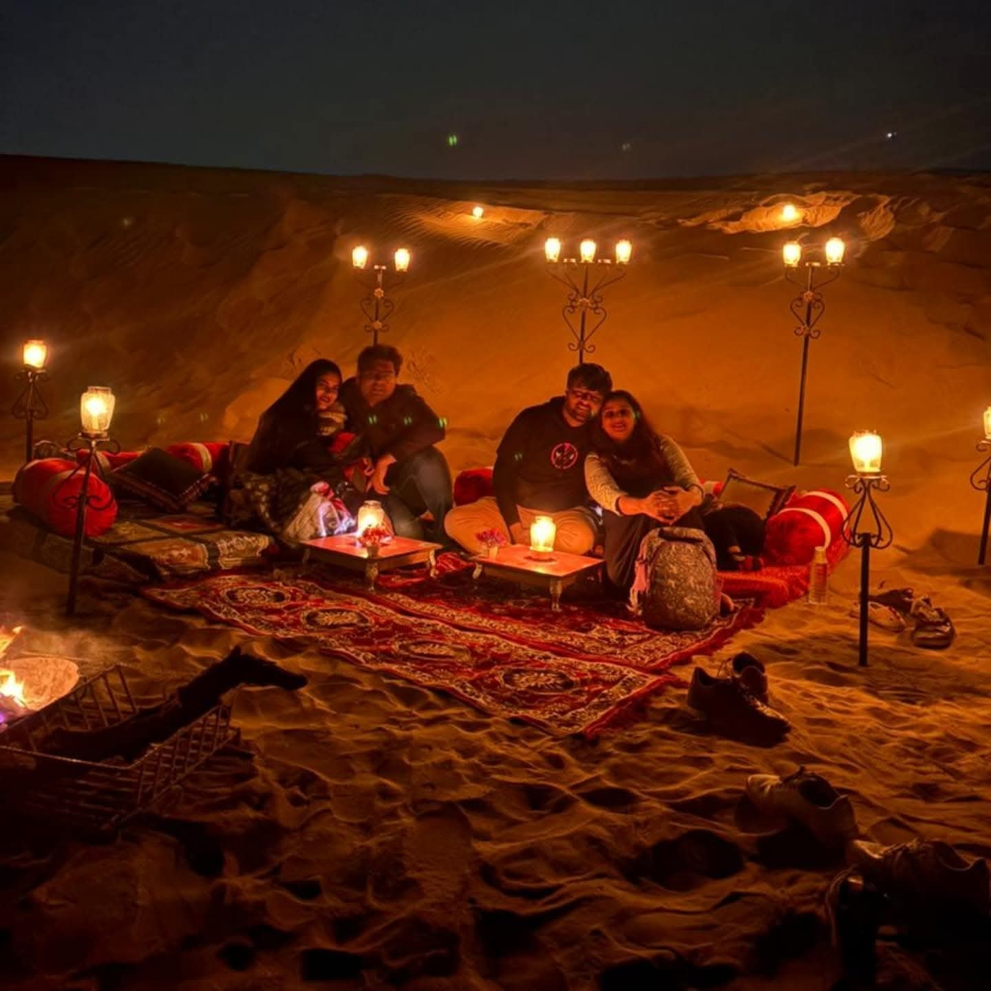 Night sky over the desert with stars visible above the dunes